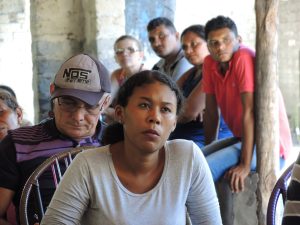 A group of people with a range of skin tones listen attentively to a community seminar in Maranhao in 2016 to address GE trees in the region.